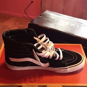 Black and white high top Vans